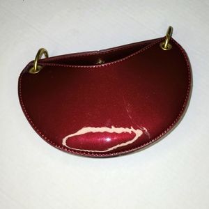 Crescent shaped patent leather purse